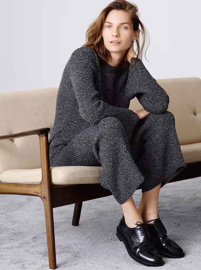 Model wearing a grey knit sweater and pants set from the Zara 2014 collection.