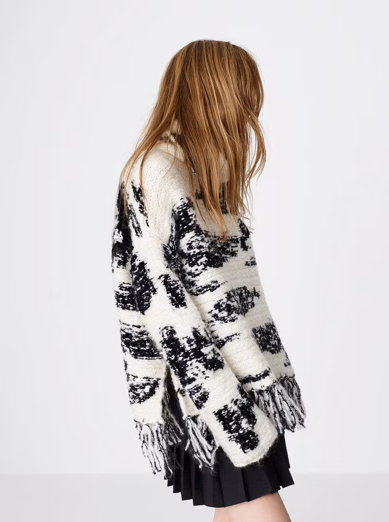 Model wearing an oversized monochrome fringe sweater from the Zara 2014 winter warmer collection.