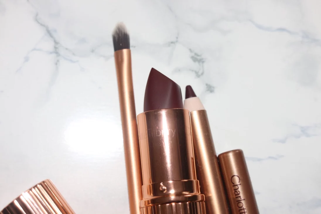 Charlotte Tilbury makeup products styled with seasonal accessories